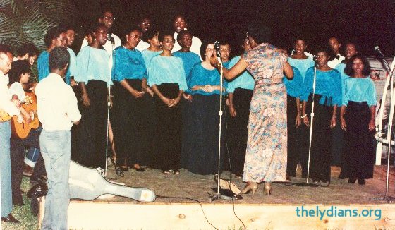 Alma Pierre conducting the Lydians at one of its community performances.